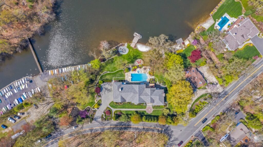 Drone aerial photo of a waterfront estate with pool